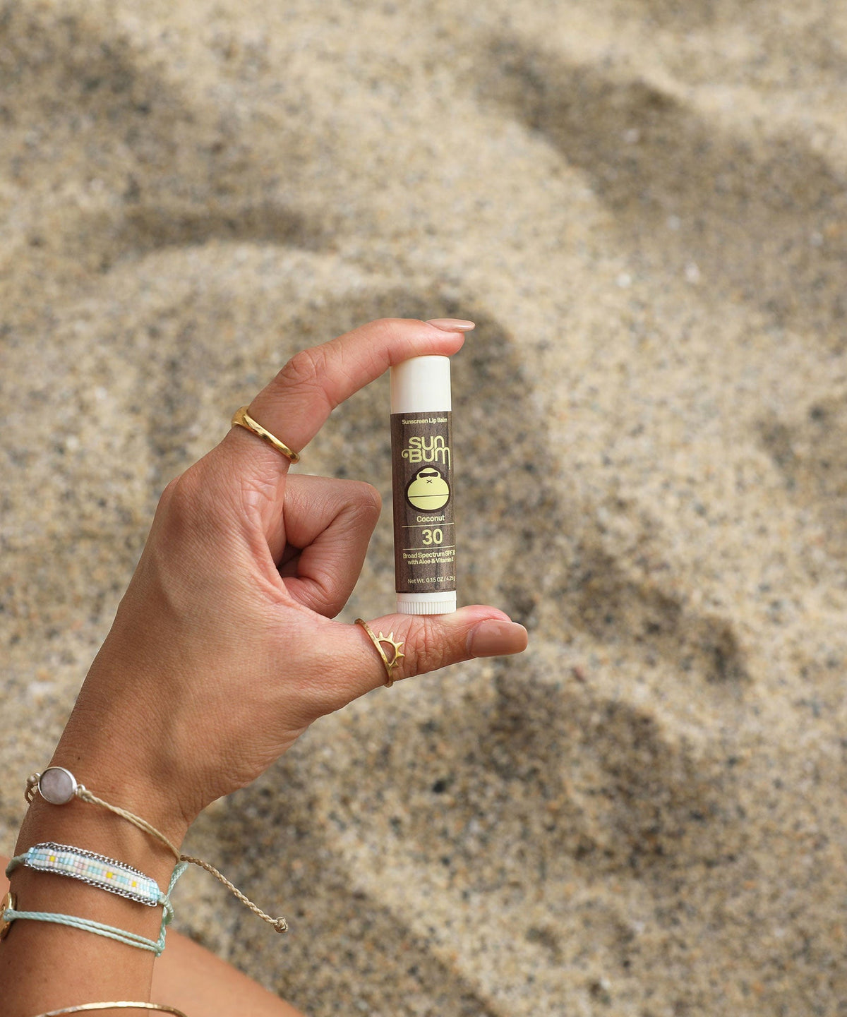 Sun Bum Coconut SPF 30 sunscreen lip balm, 0.15 oz, shown in hand